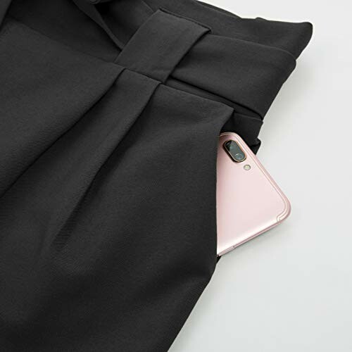 Black pants pocket with a phone partially visible.