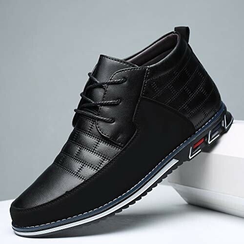 Black leather casual shoe with laces and textured design.