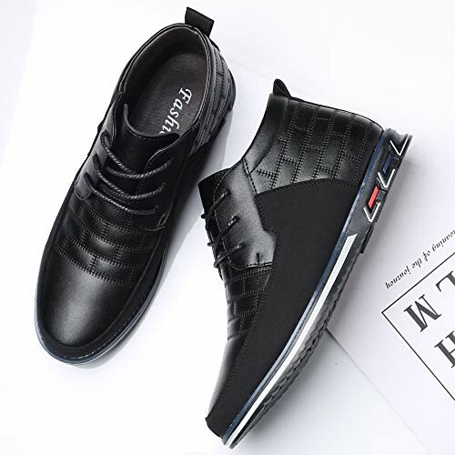Pair of black leather casual shoes with lace-up design.