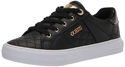 Black quilted sneaker with white sole and gold accents.