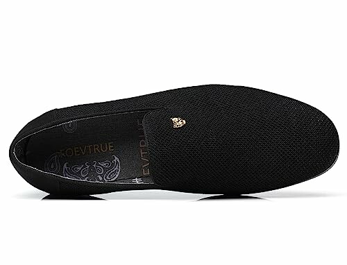 Black slip-on loafer shoe with gold embellishment