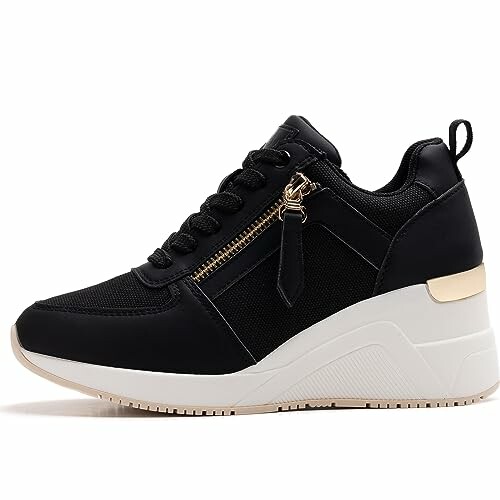 Black wedge sneaker with zipper and white sole.