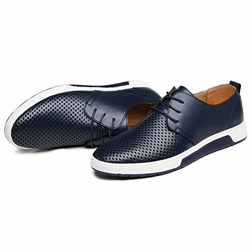 Pair of navy blue perforated leather casual shoes with white soles.