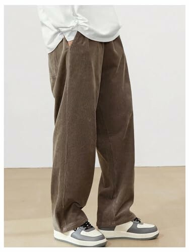 Person wearing brown corduroy pants and white sneakers.