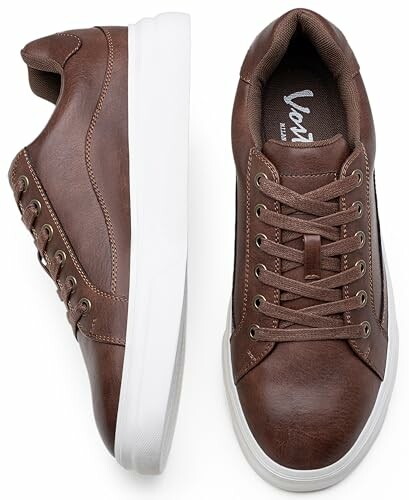 Pair of brown leather sneakers with white soles.