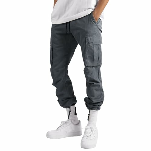 Person wearing gray cargo pants and white sneakers.