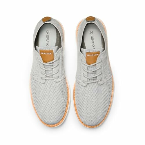 Top view of gray casual sneakers with tan accents.