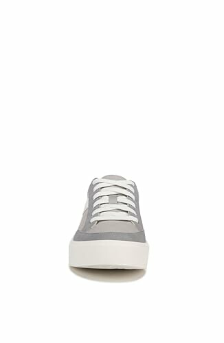Front view of a gray sneaker with white laces