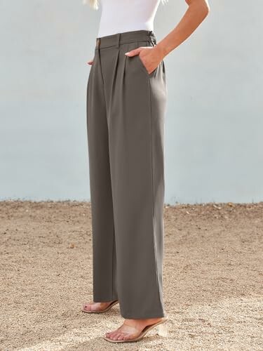 Woman wearing gray wide-leg pants and sandals.