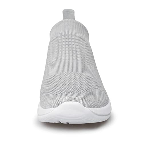 Front view of a grey slip-on sneaker with knitted upper and white sole.