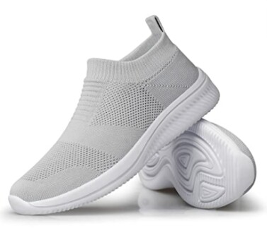 Grey slip-on sneakers with knitted design and flexible soles.