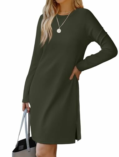 Woman wearing a long-sleeve green dress holding a gray bag