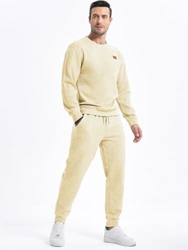 Man wearing beige sweatsuit with white sneakers