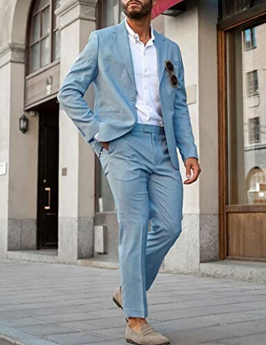 Man in blue suit walking on sidewalk