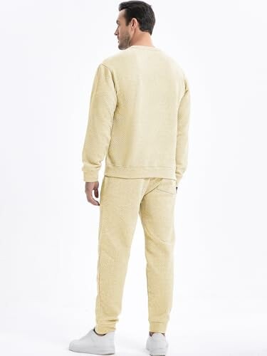 Man wearing a yellow tracksuit, facing away
