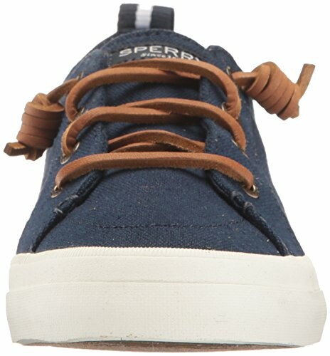 Front view of a navy canvas sneaker with brown laces.