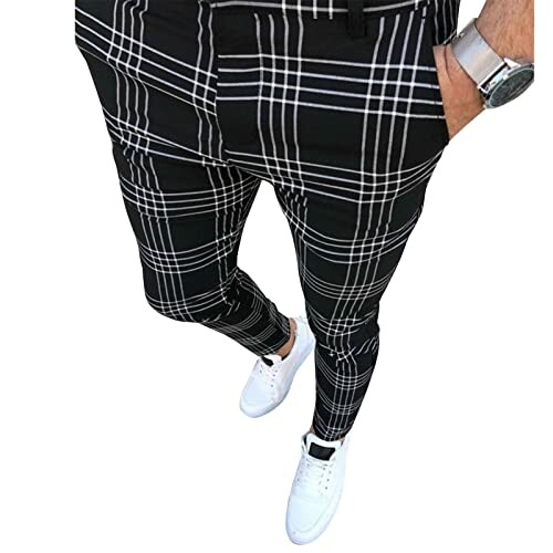 Man wearing black and white plaid pants with white sneakers.