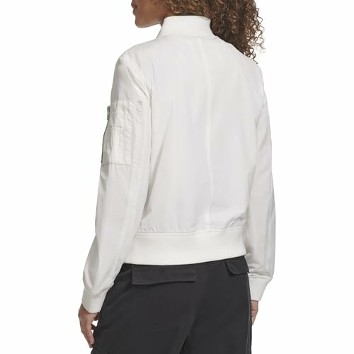 Person wearing a white bomber jacket from the back