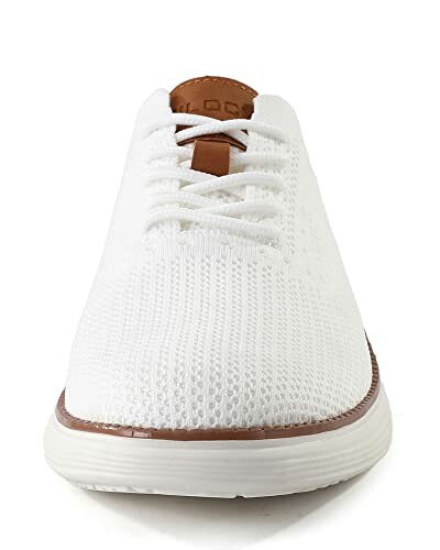 Front view of a white knit sneaker with brown accents.
