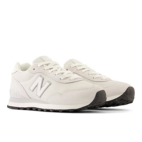 Pair of white New Balance sneakers with black soles