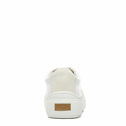 Back view of a white sneaker with a beige accent