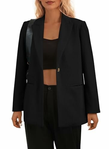 Woman wearing a black blazer and crop top