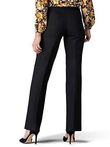 Back view of a woman wearing black trousers and heels.