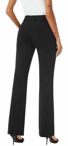 Woman wearing black trousers and black heels