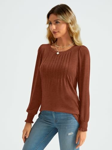 Woman wearing a brown sweater and jeans.