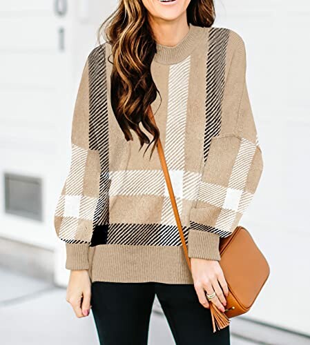 Woman wearing a plaid sweater and holding a brown purse.