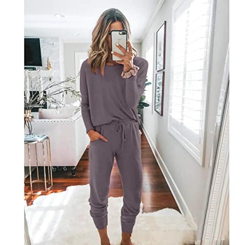 Woman taking a mirror selfie in purple loungewear set