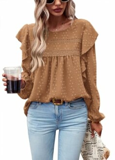 Woman in brown blouse and jeans holding a drink