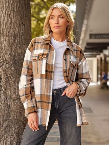 Woman in plaid jacket standing outdoors