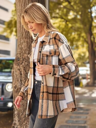 Woman in plaid shirt walking outdoors.