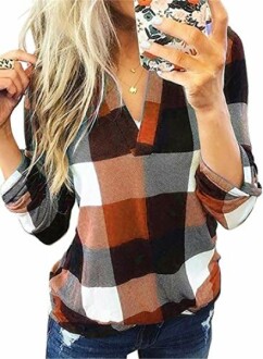 Woman taking a selfie in a plaid shirt.