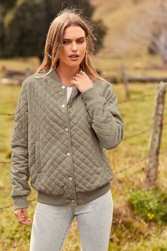 Woman wearing a quilted jacket standing outdoors in a field.