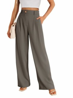 Woman in wide-leg pants holding a purse.