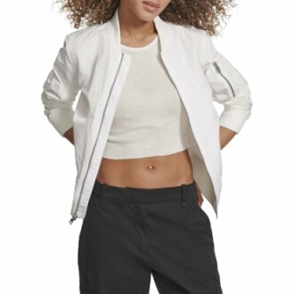 Woman wearing a white jacket and black pants.