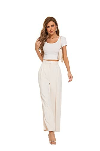 Woman in white top and pants posing